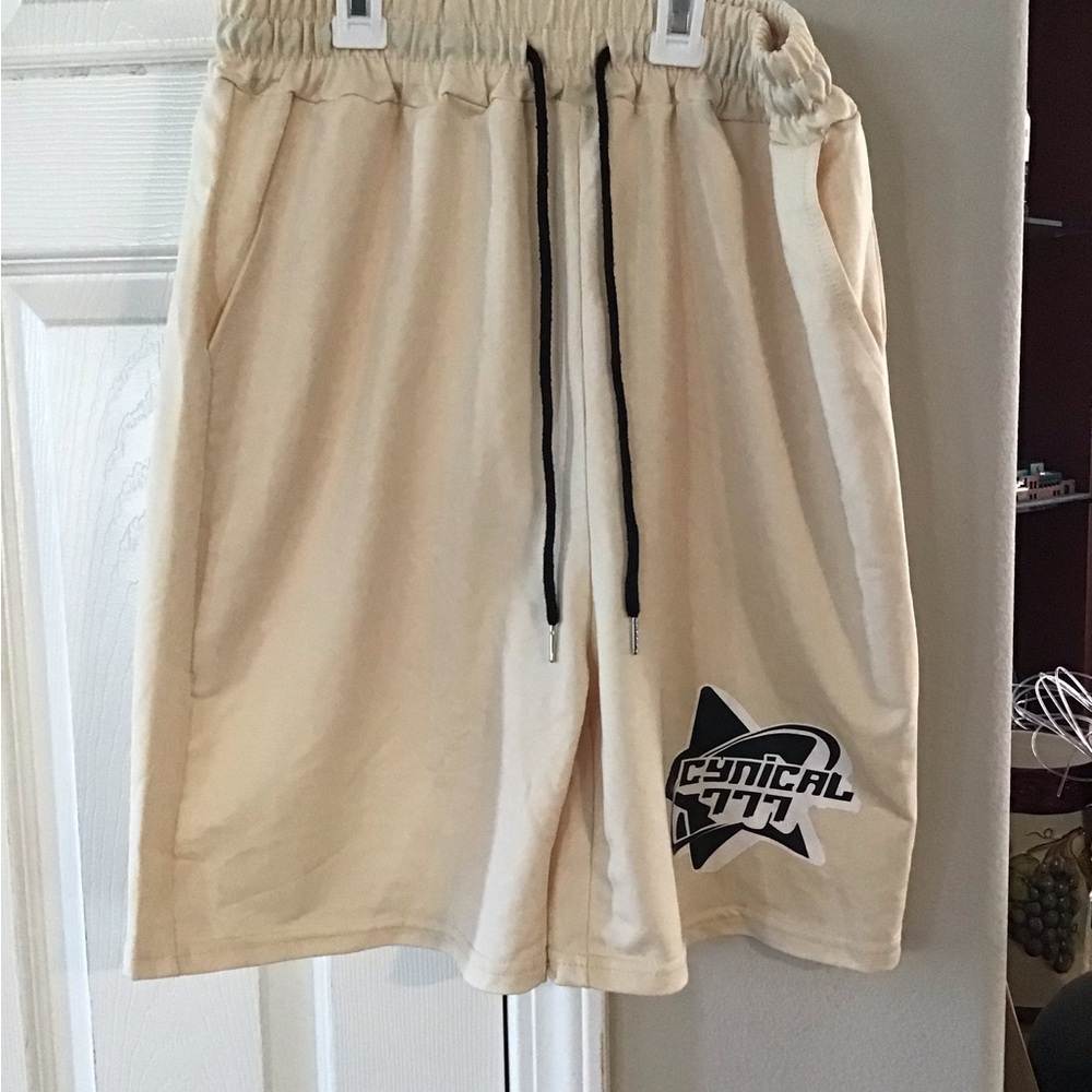Cream Athletic Shorts with Drawstring Waistband and Graphic Design